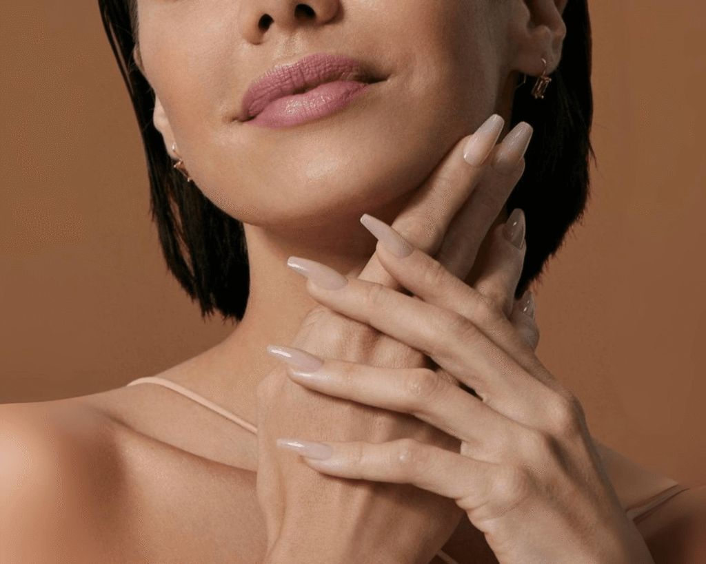 Close-up of a person with perfectly manicured hands showcasing long, natural-looking Kiss Bare But Better Press-On Nails, ideal for a TikTok beauty finds 2025 blog on trending nail art