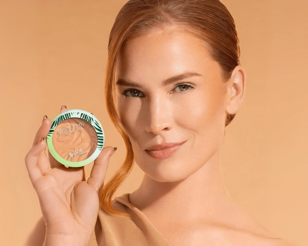 Woman holding Physicians Formula Murumuru Butter Bronzer, showcasing a natural, sun-kissed glow for a TikTok beauty finds 2025 makeup feature.