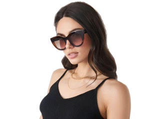 Woman wearing Le Specs Air Heart oversized brown sunglasses and a black tank top – chic accessory featured in the Budget Fashion 2025 blog.